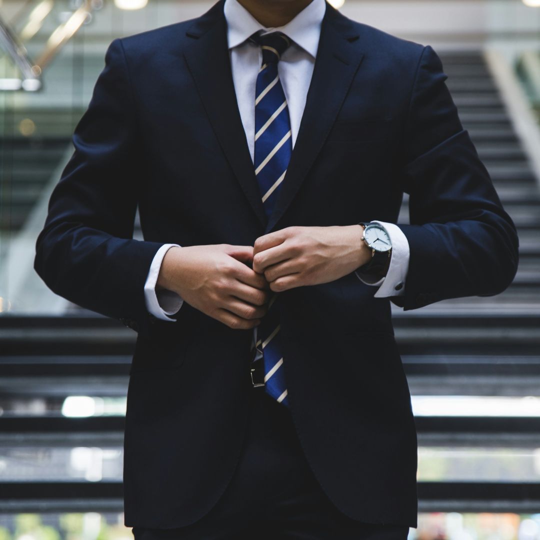 Close up of Australian litigation lawyer in a dark blue suit and tie